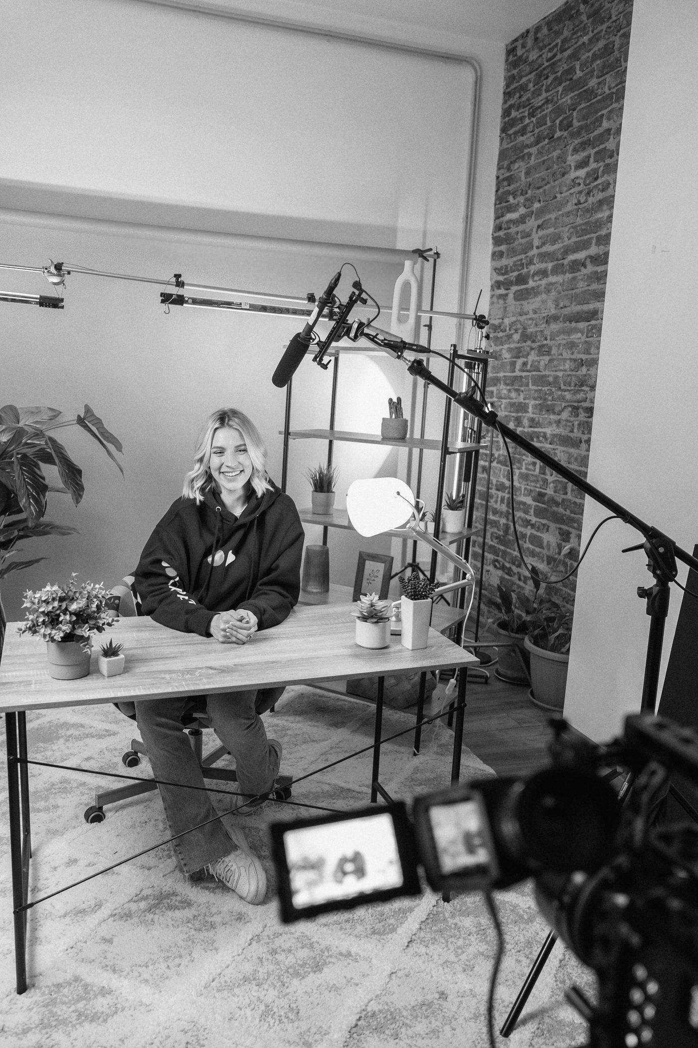 A videographer working on set, camera rig in hand.